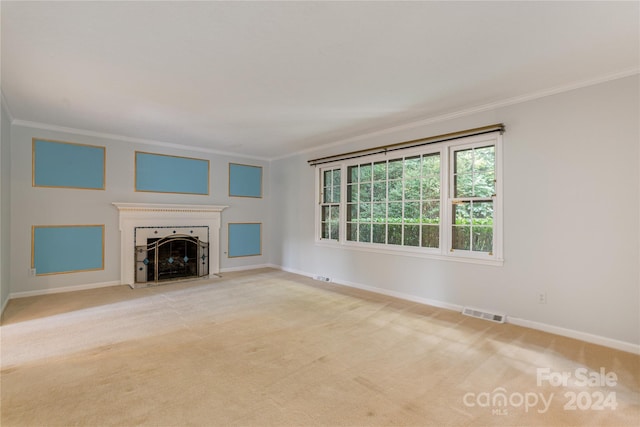 unfurnished living room featuring crown molding and light carpet