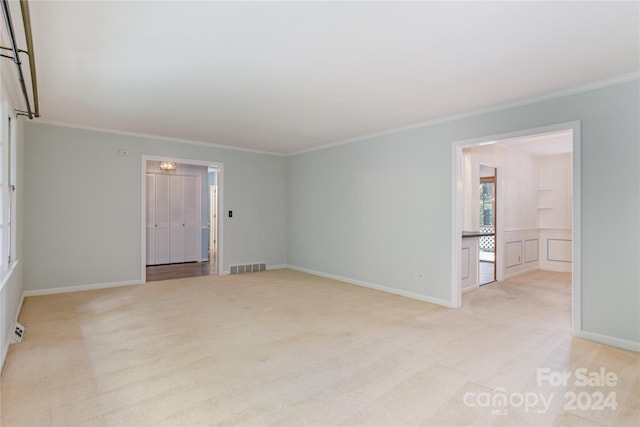 carpeted spare room with ornamental molding