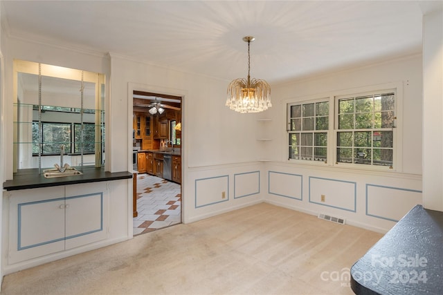 dining space with light carpet, sink, ceiling fan with notable chandelier, and ornamental molding