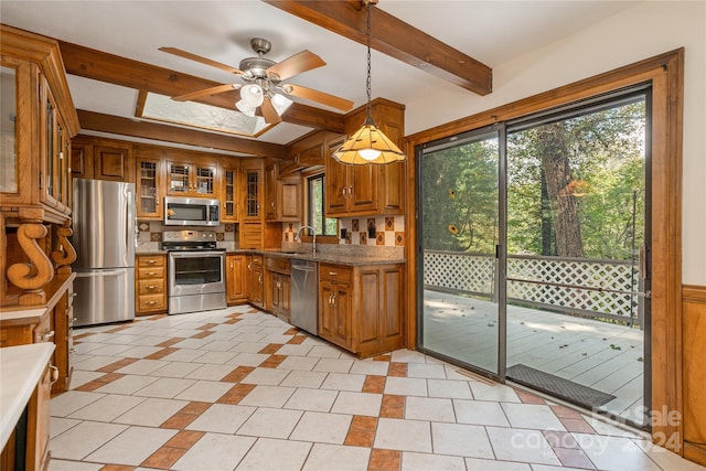 1010 Indian Hill Rd, Hendersonville, NC 28791 - kitchen with stainless steel appliances, brown cabinets, healthy amount of natural light, and beamed ceiling