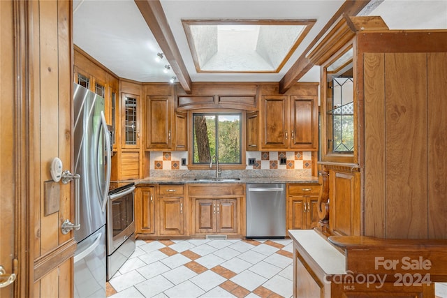 1010 Indian Hill Rd, Hendersonville, NC 28791 - kitchen featuring appliances with stainless steel finishes, a sink, and brown cabinetry