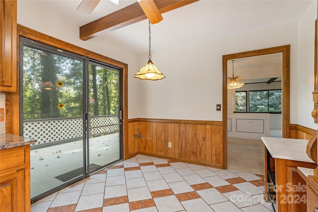 1010 Indian Hill Rd, Hendersonville, NC 28791 - unfurnished dining area featuring a wainscoted wall, beam ceiling, light tile patterned flooring, ceiling fan, and wooden walls