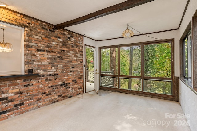 unfurnished sunroom featuring beamed ceiling and an inviting chandelier