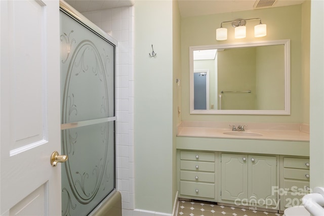 1010 Indian Hill Rd, Hendersonville, NC 28791 - full bath featuring vanity, toilet, and combined bath / shower with glass door