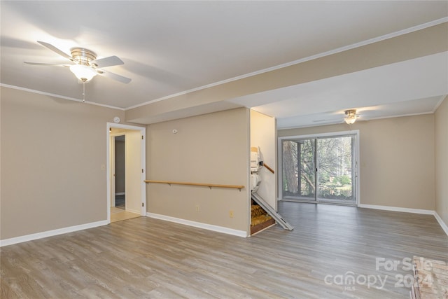 empty room with light wood-type flooring, ceiling fan, and crown molding