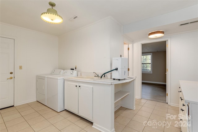 1010 Indian Hill Rd, Hendersonville, NC 28791 - laundry room with washer and dryer, light tile patterned floors, cabinet space, baseboards, and crown molding