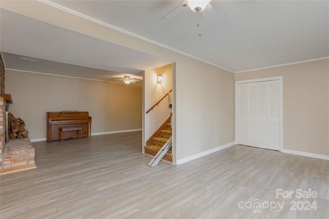 basement featuring ceiling fan, light hardwood / wood-style flooring, and ornamental molding