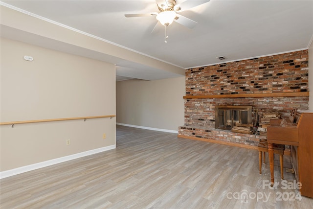 unfurnished living room with ceiling fan, a fireplace, and light wood-type flooring