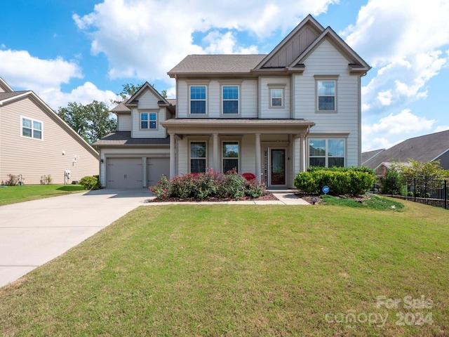 craftsman house with a front lawn and a garage