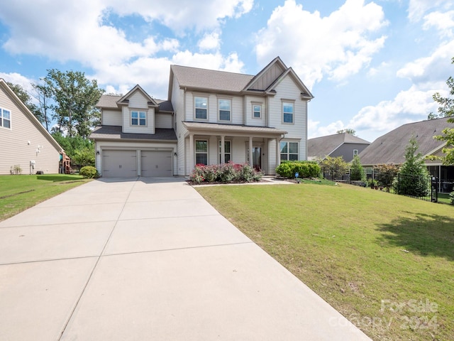 craftsman house with a front yard, a porch, and a garage