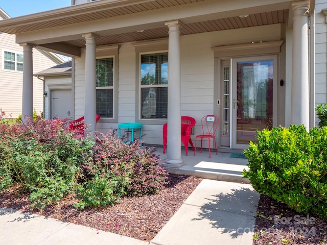 doorway to property featuring covered porch