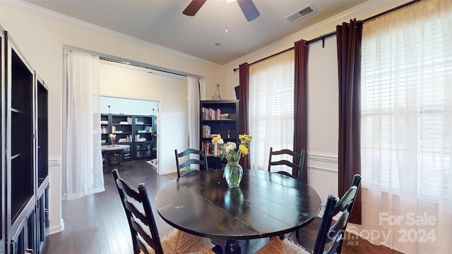 dining space featuring a healthy amount of sunlight, dark hardwood / wood-style floors, ceiling fan, and ornamental molding