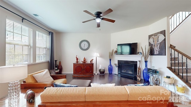 living room featuring ceiling fan and hardwood / wood-style floors