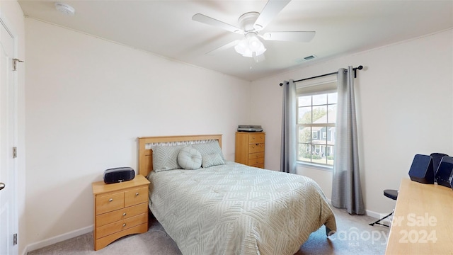 bedroom with ceiling fan and light carpet