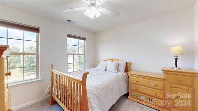 bedroom featuring ceiling fan and light carpet