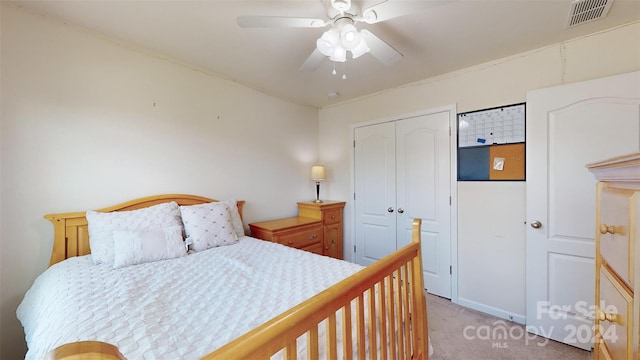 carpeted bedroom with ceiling fan and a closet