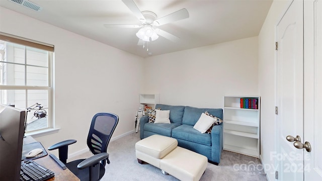 office featuring ceiling fan and light carpet