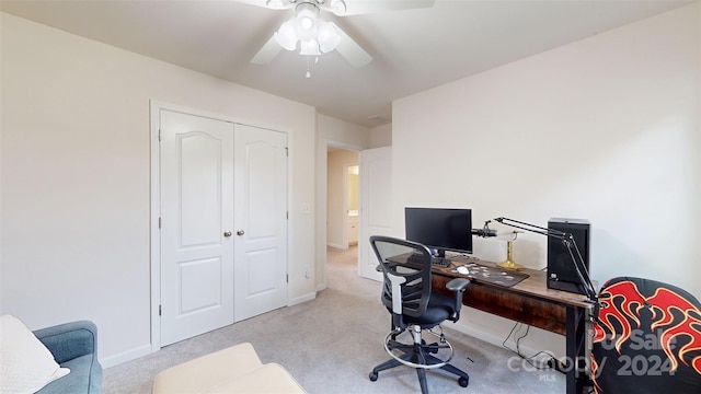 carpeted office space with ceiling fan