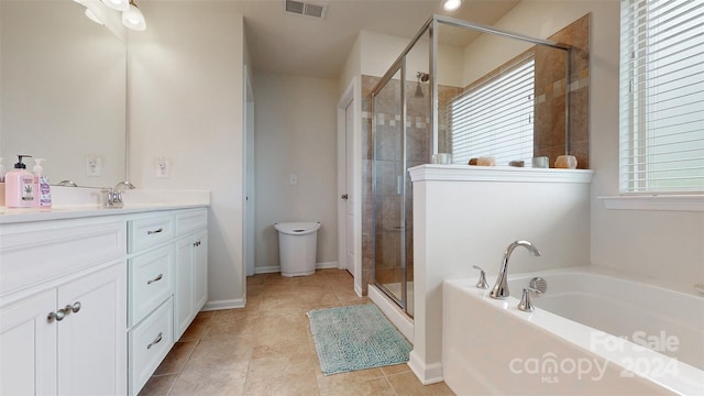 bathroom featuring tile patterned flooring, vanity, plenty of natural light, and independent shower and bath