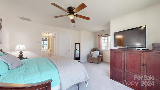 carpeted bedroom with ceiling fan and ensuite bathroom