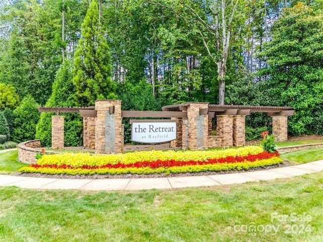 community / neighborhood sign with a lawn