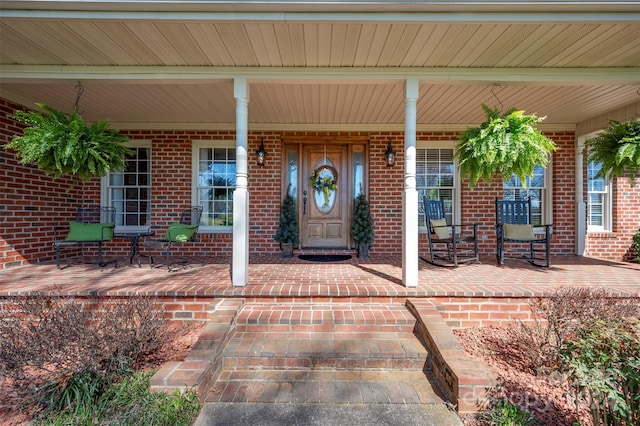 view of exterior entry with a porch