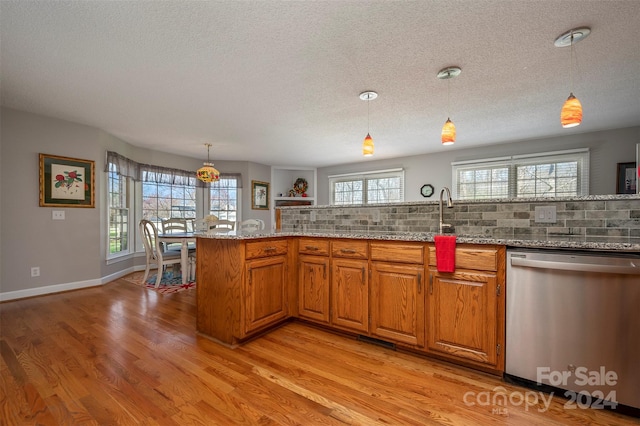 29 Daves Rd, Mooresboro, NC 28114 - kitchen featuring stainless steel dishwasher, a textured ceiling, light wood-style flooring, backsplash, and brown cabinets