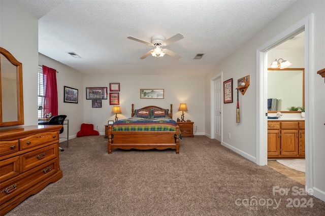 carpeted bedroom featuring ceiling fan, connected bathroom, and a textured ceiling