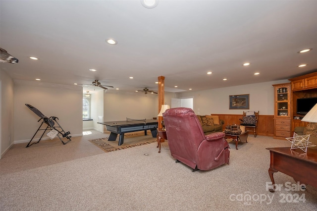 carpeted living room with ceiling fan