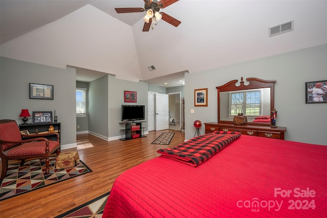 bedroom with ceiling fan, wood-type flooring, and lofted ceiling