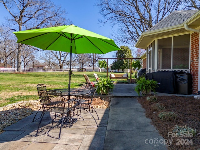 view of patio featuring a sunroom