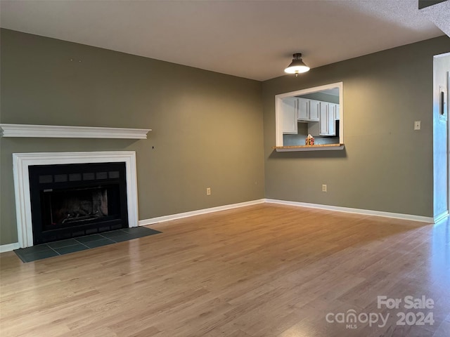 unfurnished living room with light wood-type flooring