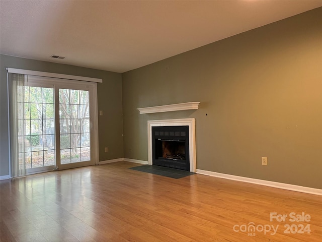 unfurnished living room featuring light hardwood / wood-style flooring