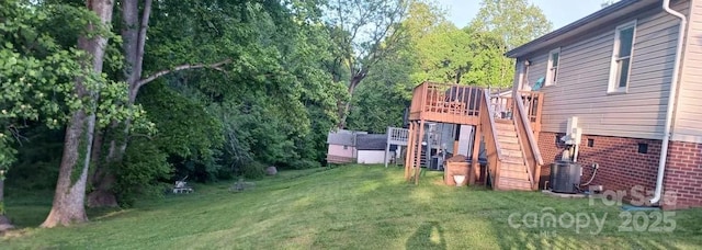 view of yard with a deck and central air condition unit