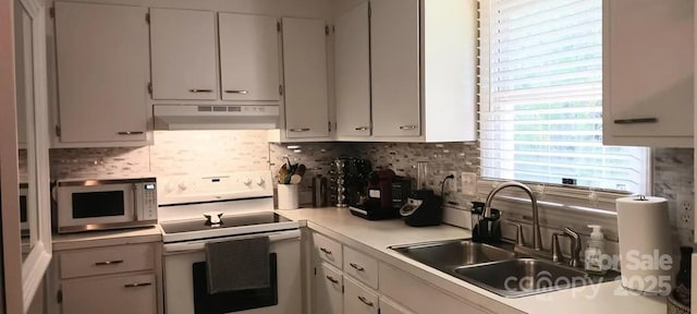 kitchen featuring decorative backsplash, electric range, white cabinetry, and sink