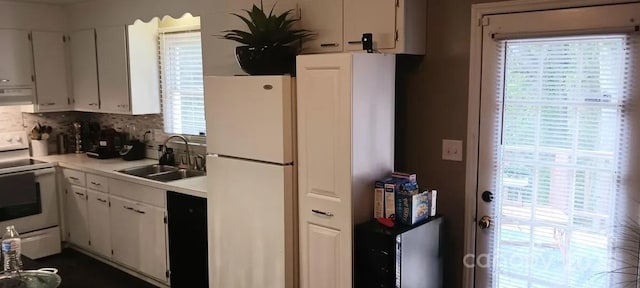 kitchen featuring white cabinetry, sink, a healthy amount of sunlight, white appliances, and exhaust hood