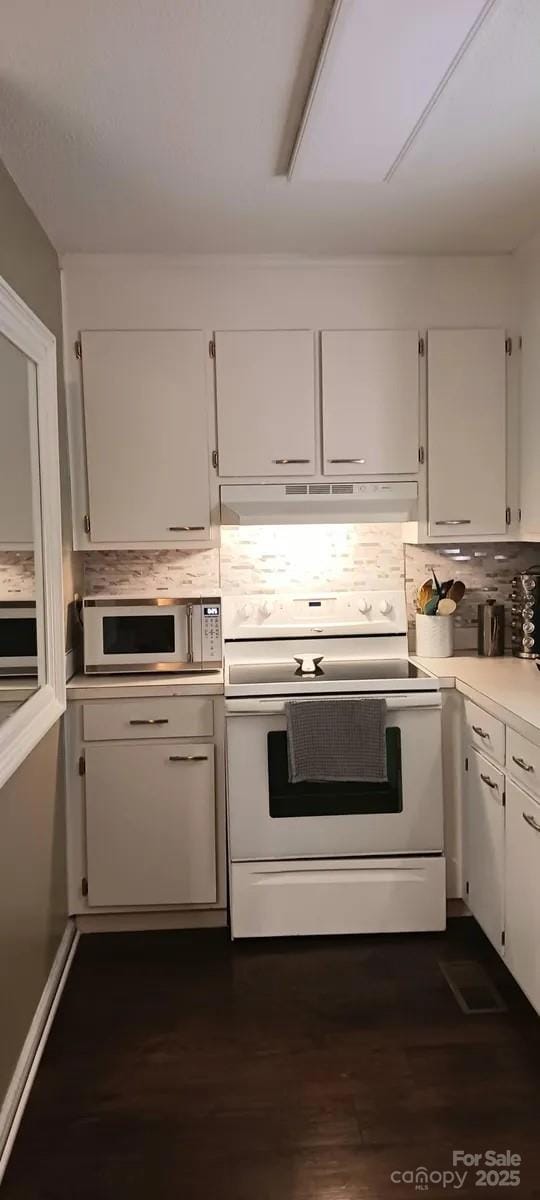 kitchen featuring tasteful backsplash, dark hardwood / wood-style flooring, white cabinets, and white appliances