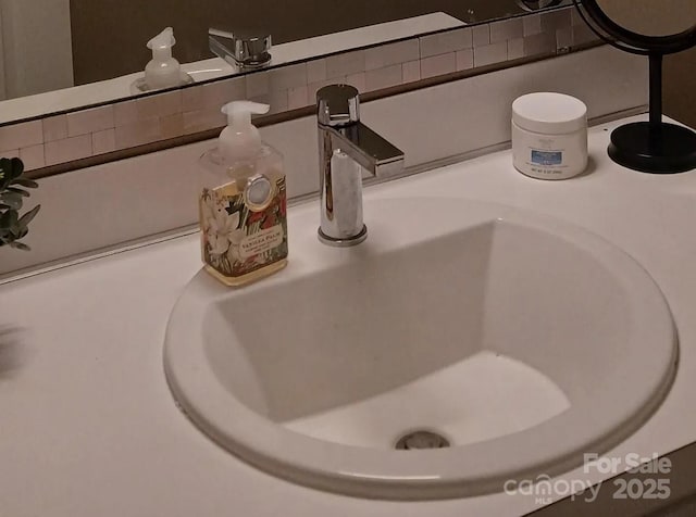 room details featuring decorative backsplash and vanity