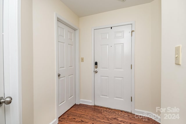 entryway with dark hardwood / wood-style flooring