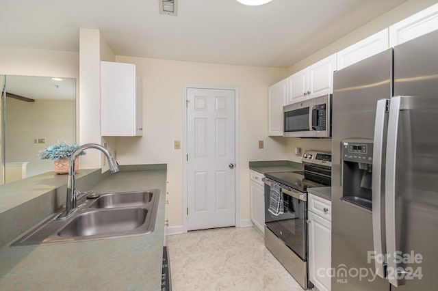 kitchen featuring white cabinetry, appliances with stainless steel finishes, and sink