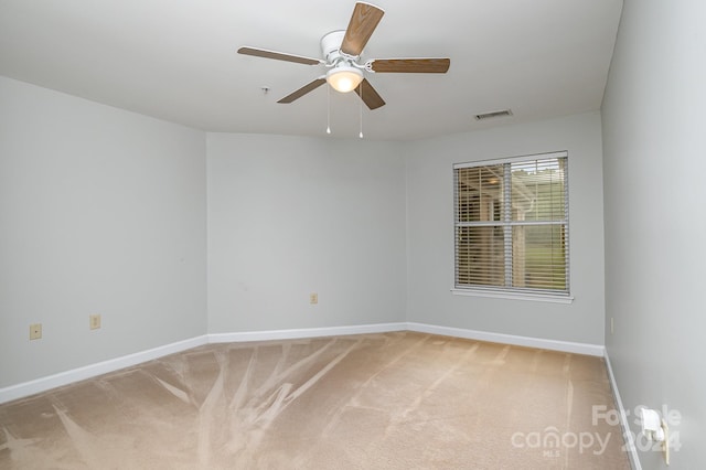 carpeted empty room featuring ceiling fan