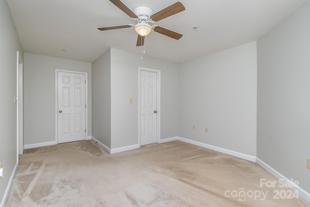 unfurnished bedroom featuring carpet flooring and ceiling fan