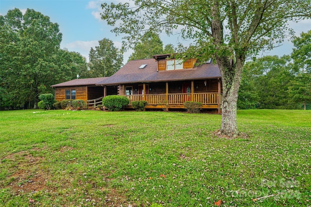 rear view of property featuring a deck and a yard