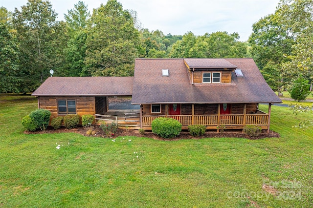 view of front facade featuring a front lawn and a wooden deck