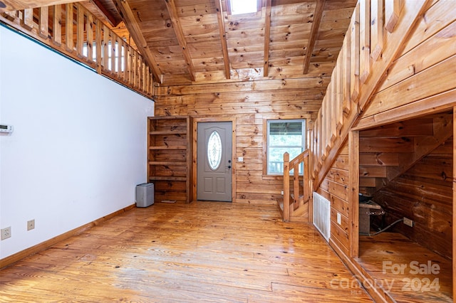 entryway with light hardwood / wood-style flooring, lofted ceiling with beams, and wooden ceiling