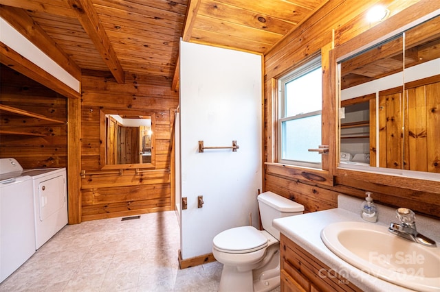 bathroom featuring wood ceiling, wooden walls, separate washer and dryer, vanity, and toilet