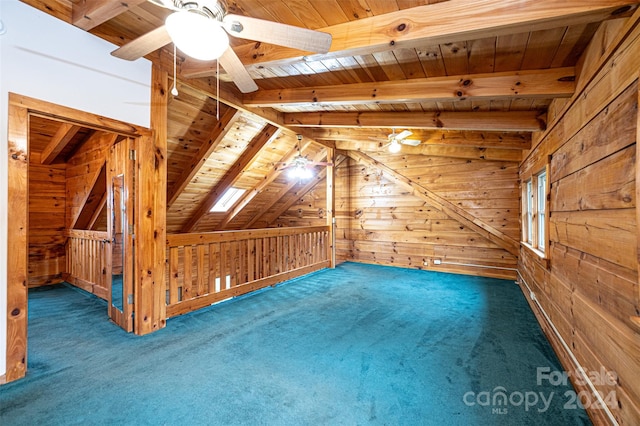 additional living space with dark carpet, wood ceiling, wood walls, and ceiling fan