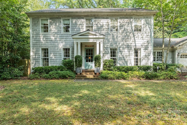 colonial home with a front lawn