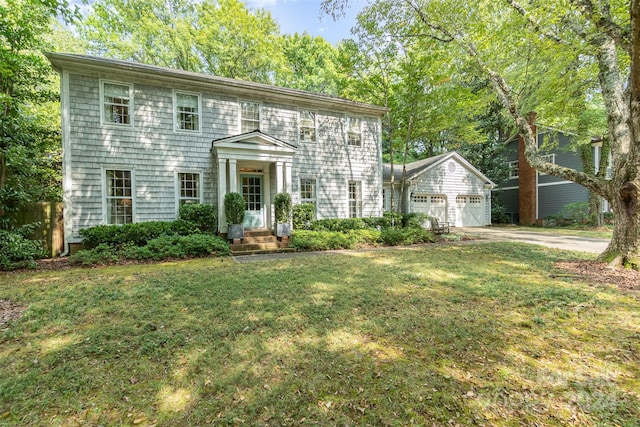 colonial house with a garage and a front yard