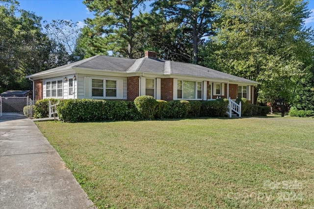 ranch-style house with a front lawn